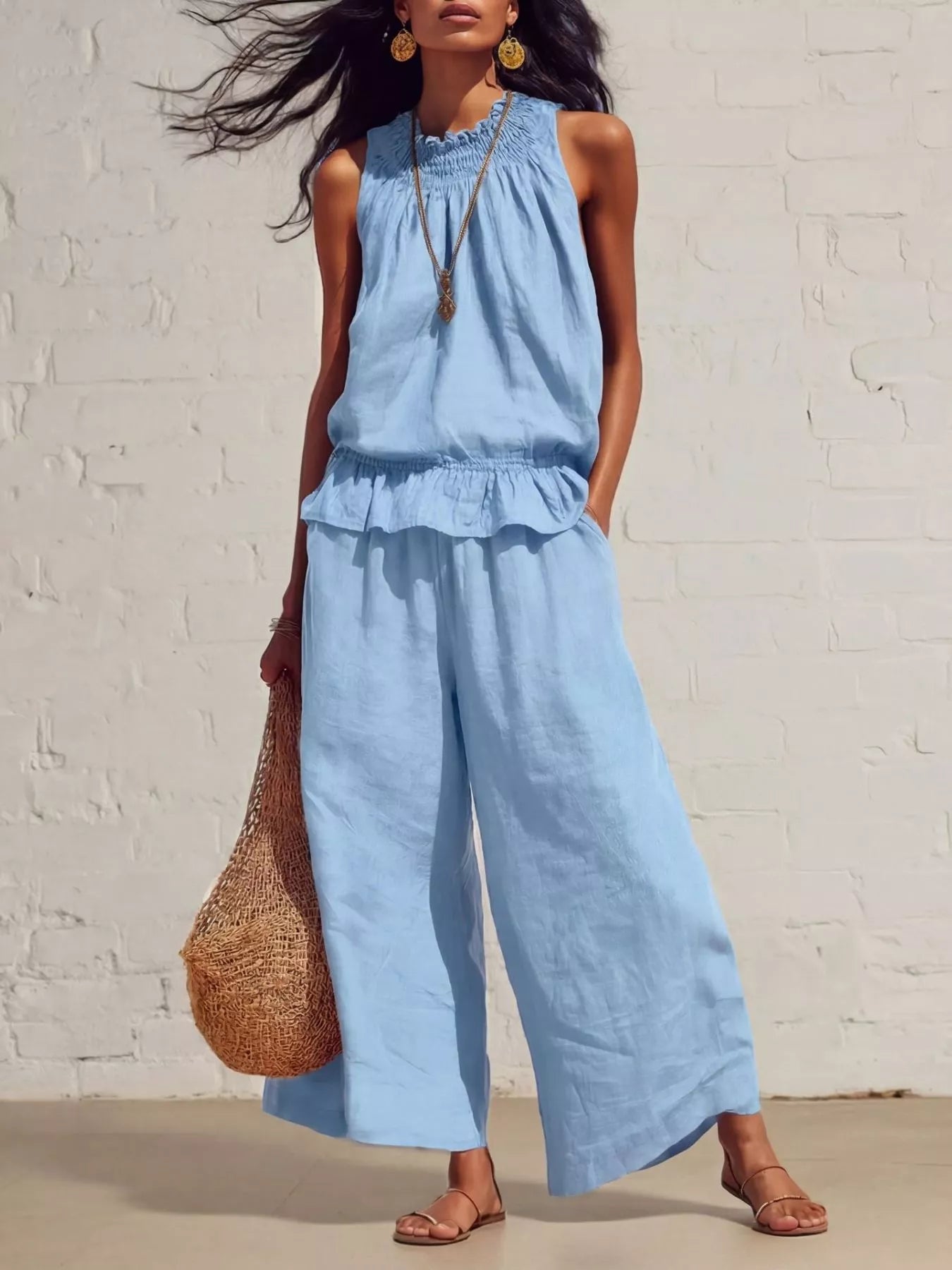 Light blue sleeveless smocked ruffled hem top and wide-leg pants set with tiered ruffle.