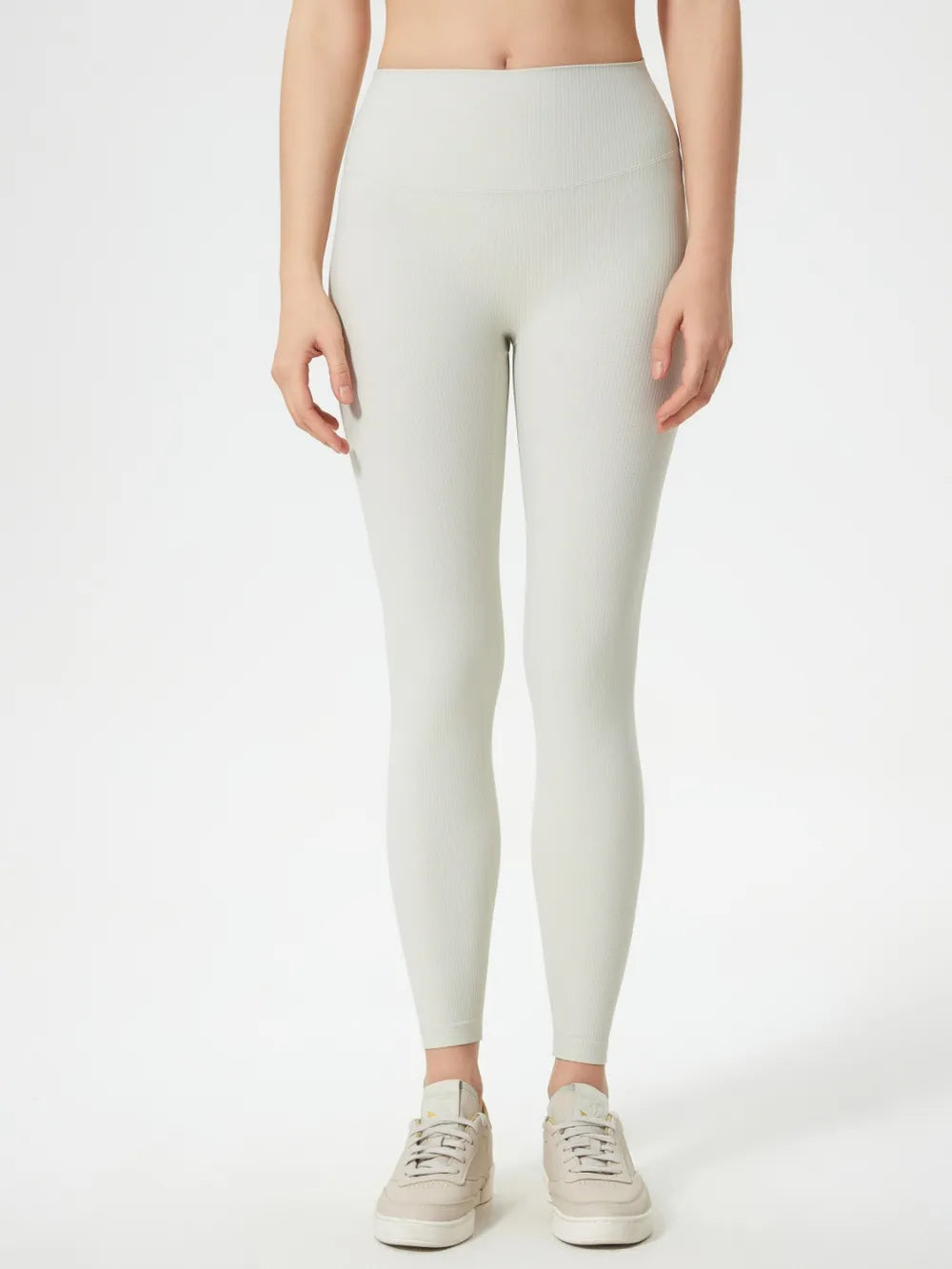 Light cream high-waist active leggings, full-length fitted pants with high rise.