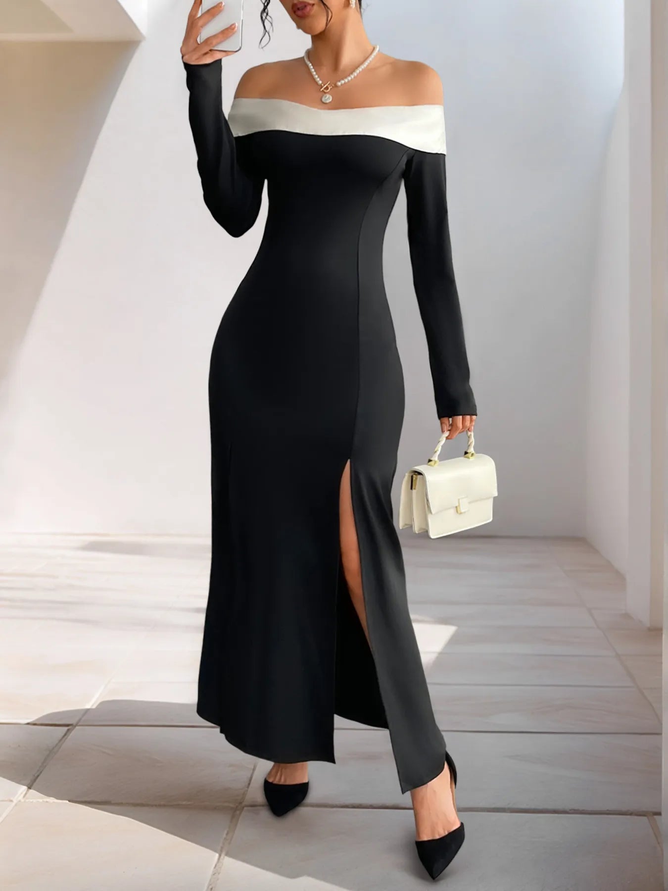 Black off-shoulder maxi dress with contrast neckline, side slit detail on skirt