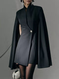 Black fitted mini blazer dress with cape sleeves and one-button front closure
