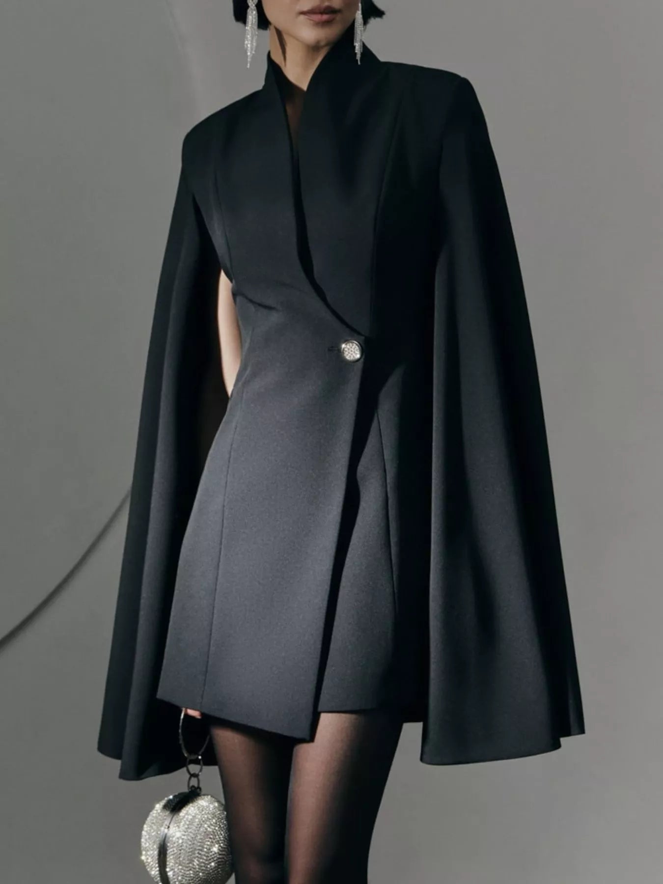 Black fitted mini blazer dress with cape sleeves and one-button front closure