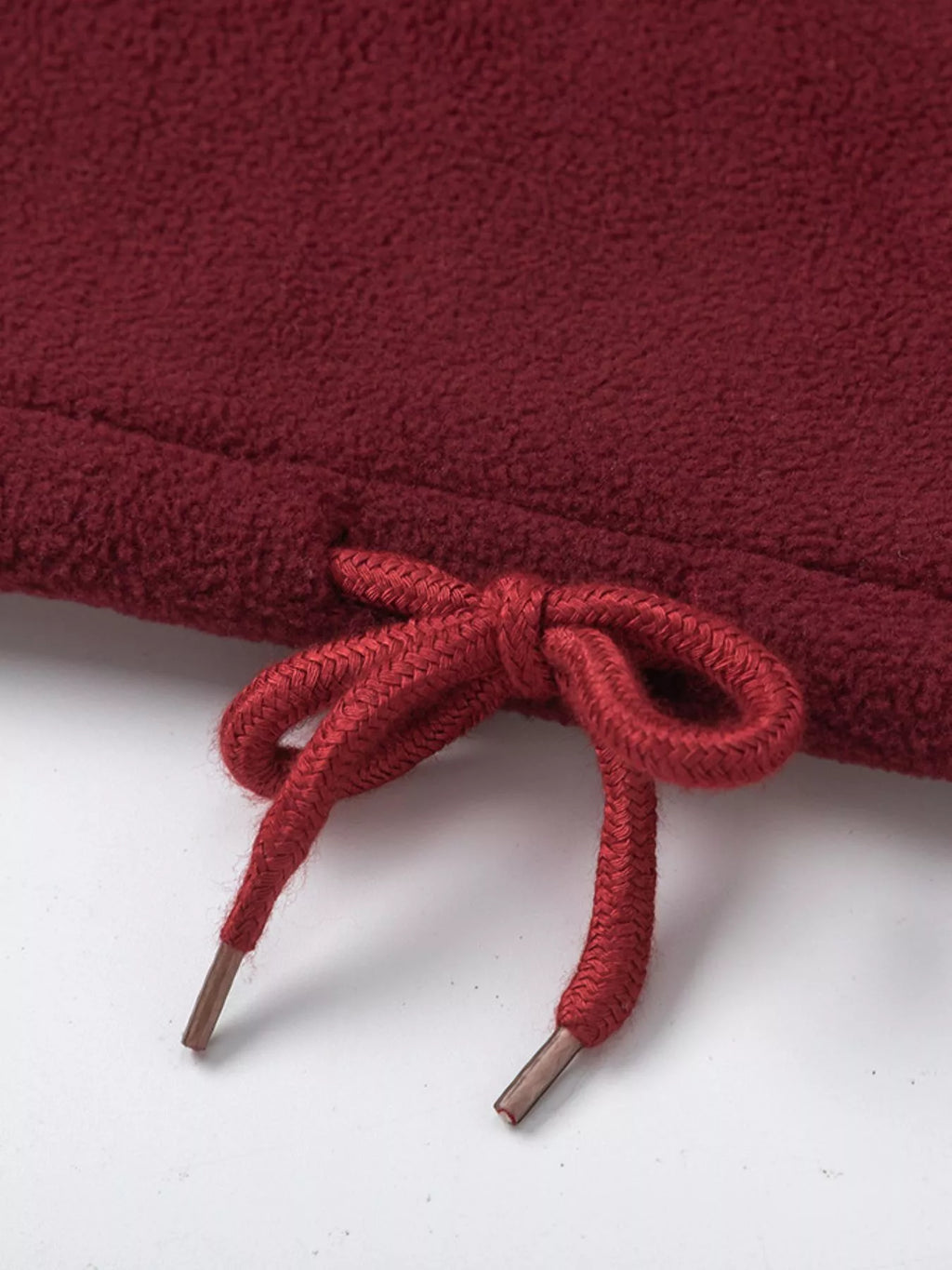 Burgundy sweatshirt hem with drawstring tie cords
