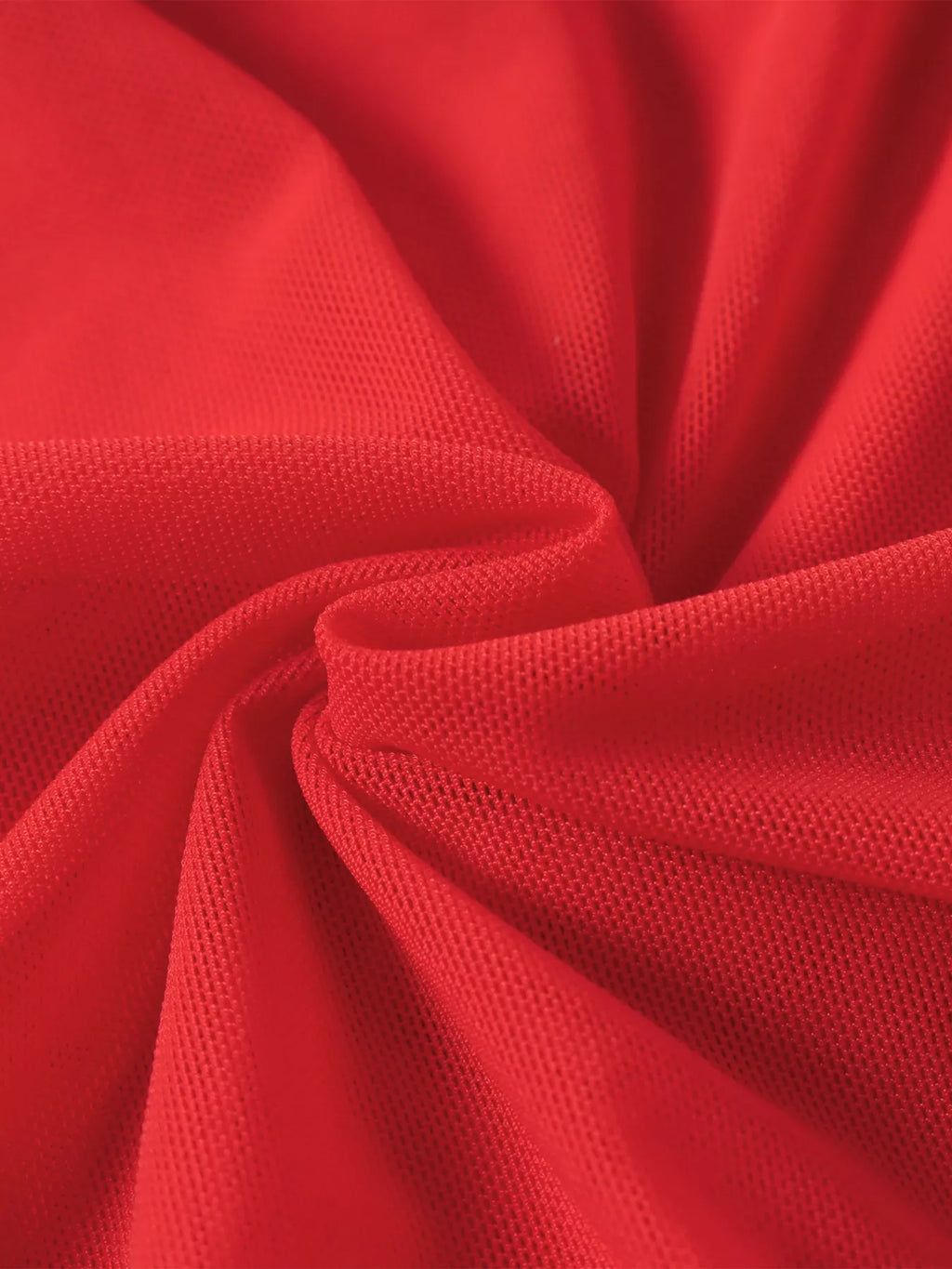 Red ruched fabric closeup showing draped, gathered texture at seam