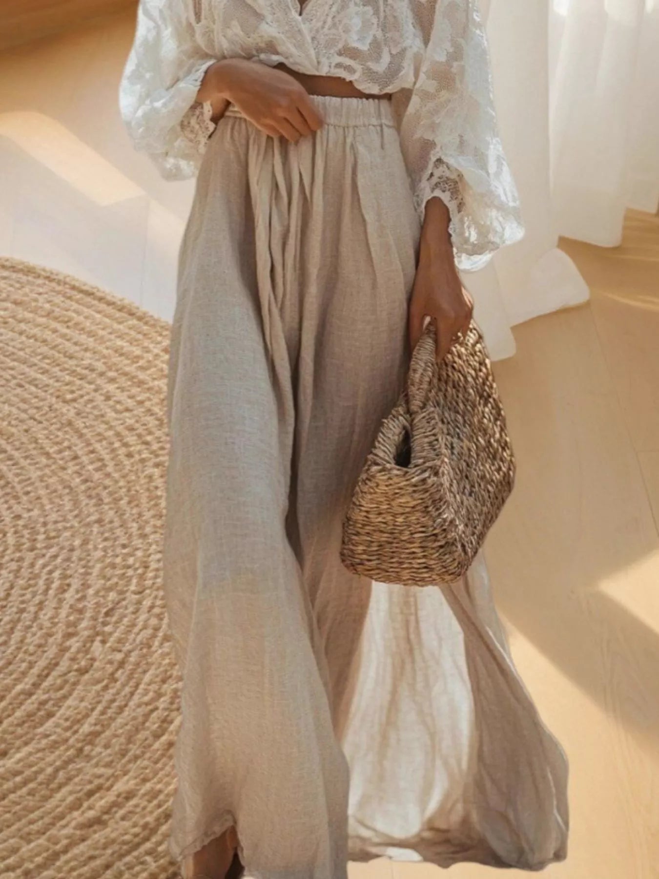 Cream lace long-sleeve top paired with pleated light beige maxi skirt