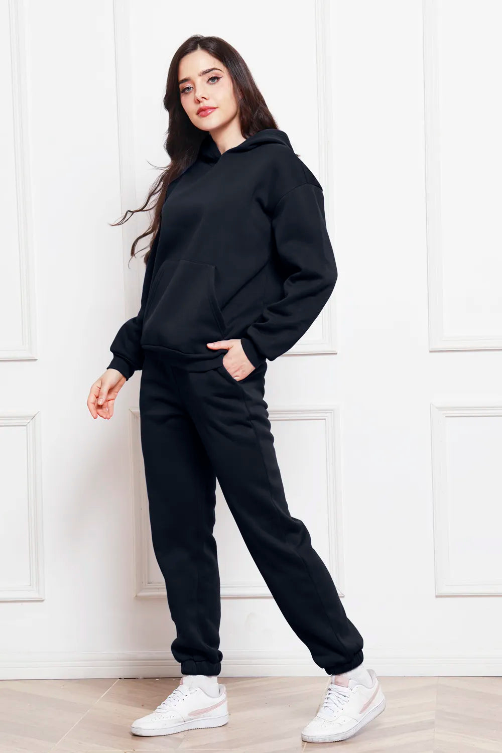 Hoodie and pants set in black, side view with drop-shoulder hoodie and jogger cuffs