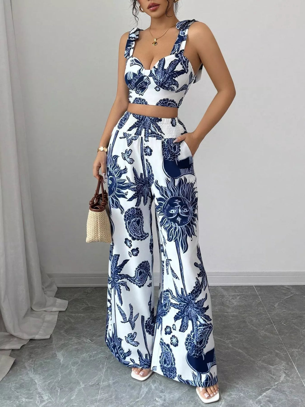 Blue and white floral crop top and wide-leg pants set, sleeveless with tied waist