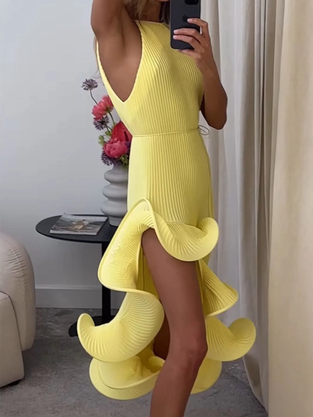 Yellow ribbed sleeveless dress with ruffle hem, front slit and cascading side ruffles