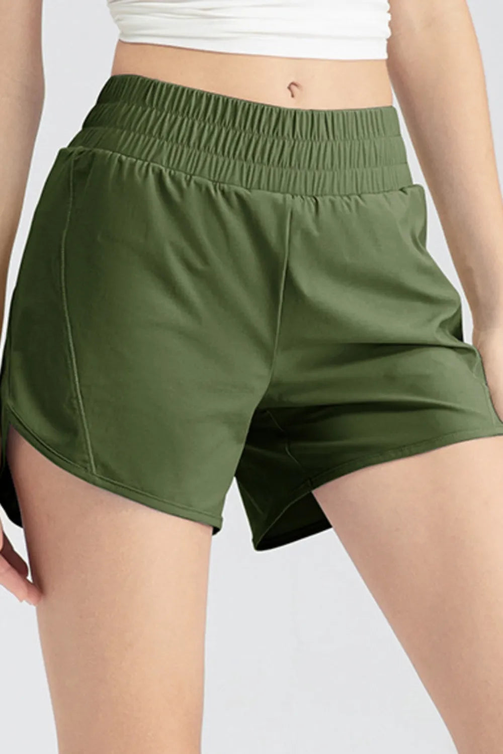 Matcha green elastic waist active shorts with side pocket seams and roomy fit