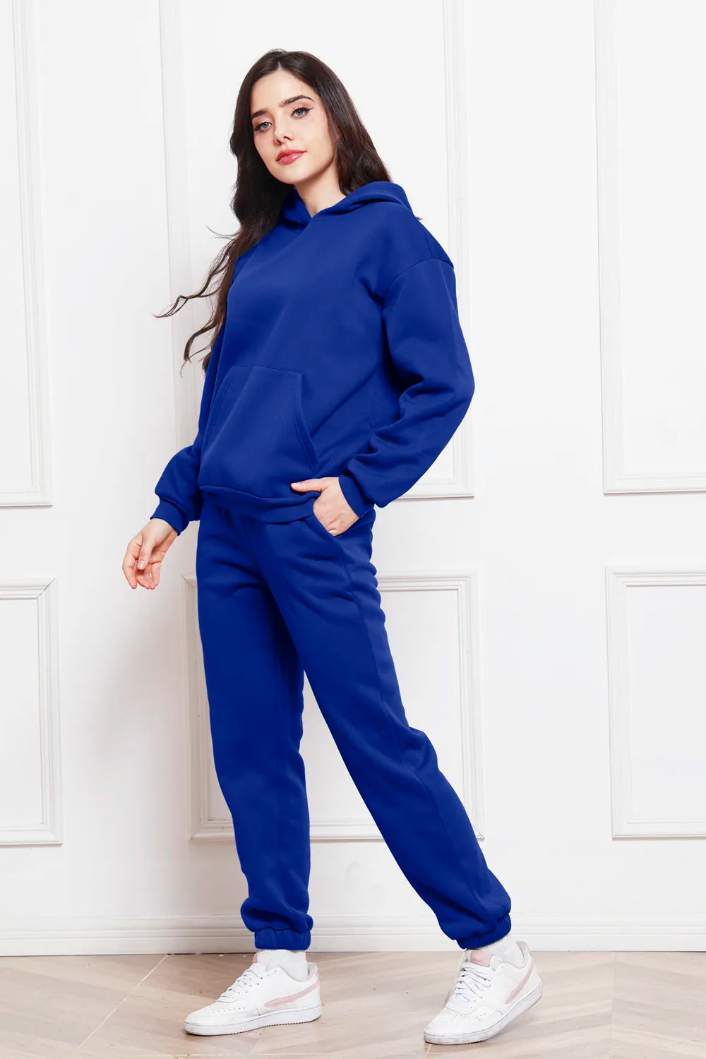 Hoodie and pants set in dark blue, side view with relaxed hoodie and jogger legs