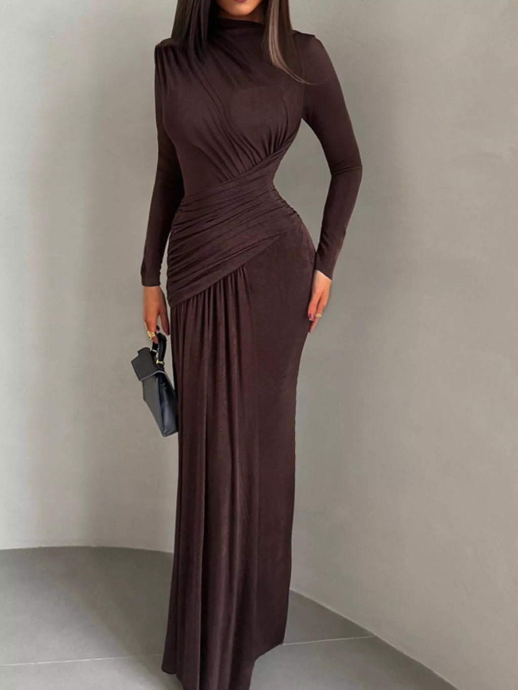 Brown long-sleeve maxi dress with high neck, ruched center detail, flowing skirt