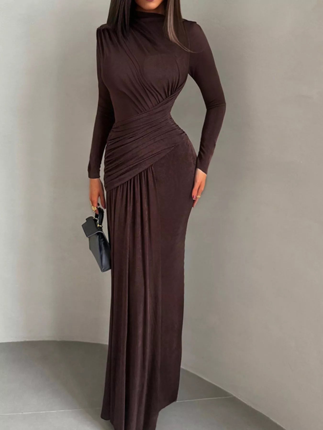 Brown long-sleeve maxi dress with high neck, ruched center detail, flowing skirt