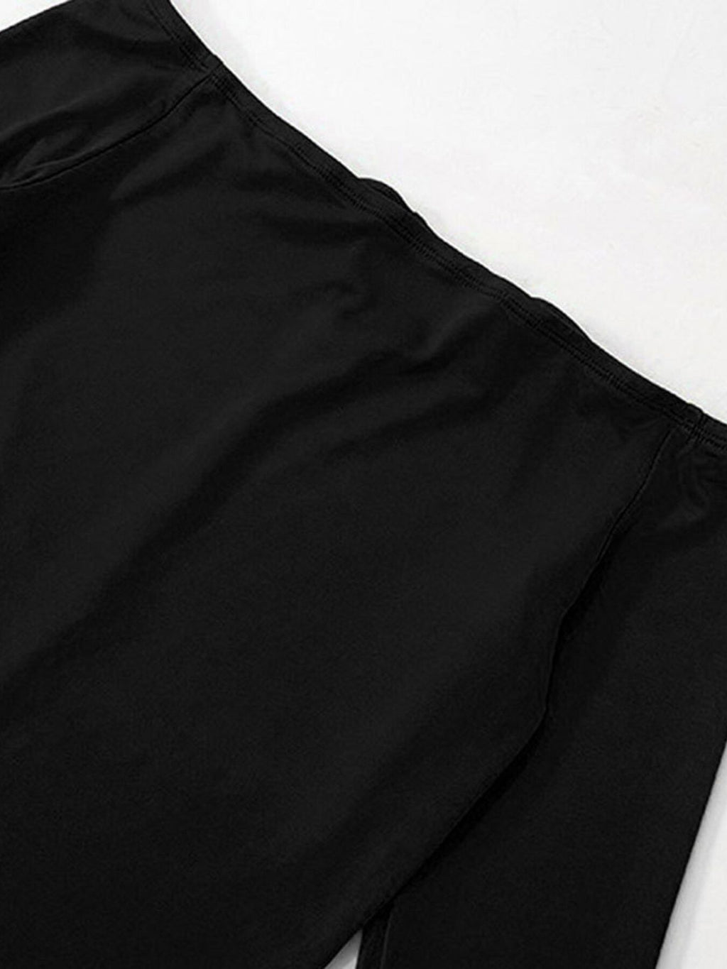Close-up of black off-shoulder neckline seam and smooth fitted bodice
