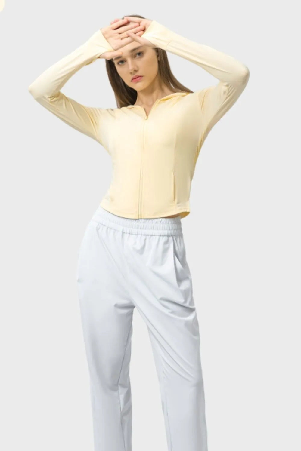 Light yellow zip-up hooded active jacket with long sleeves