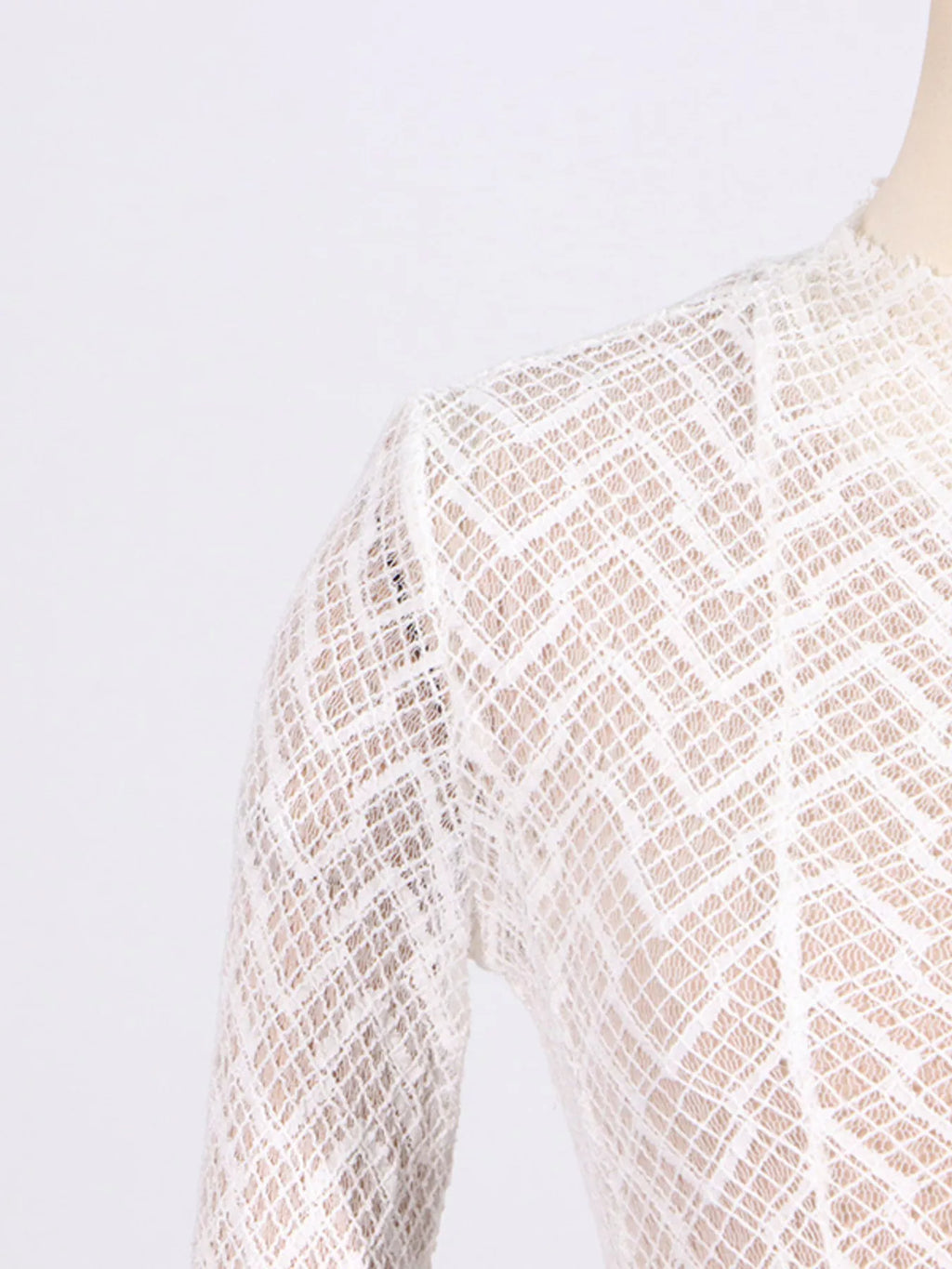 White lace long-sleeve maxi dress, shoulder and upper torso with openwork texture