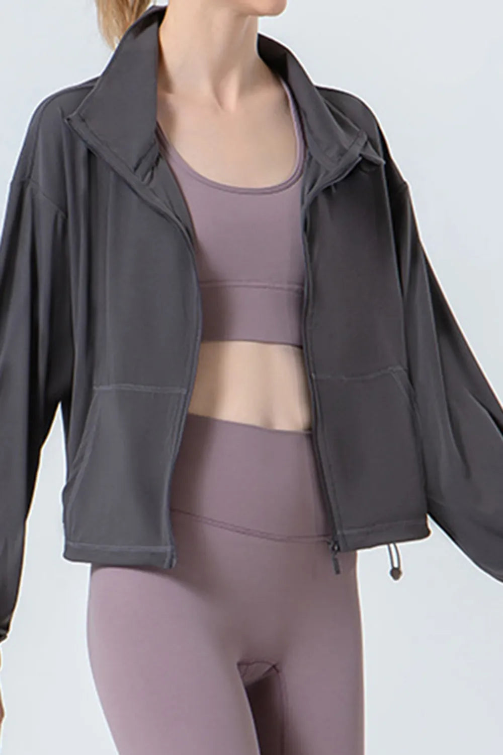 Dark gray zip-up active jacket with stand collar, front zipper, relaxed dropped shoulders