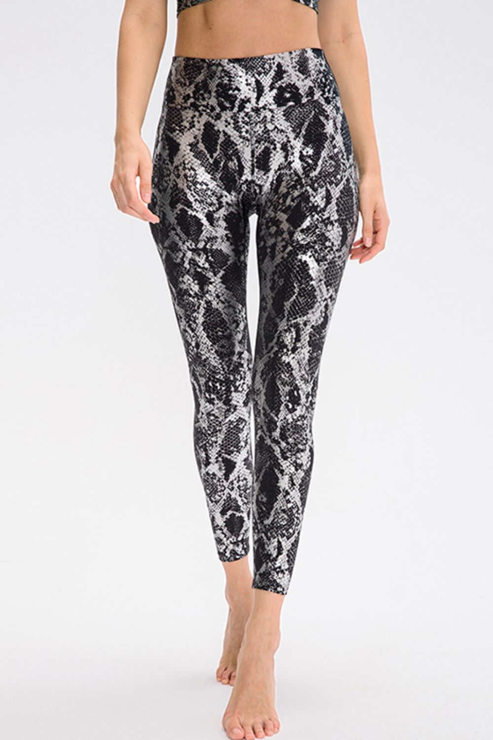 Animal-print slim-fit long sports pants with wide waistband, black and gray snake pattern.