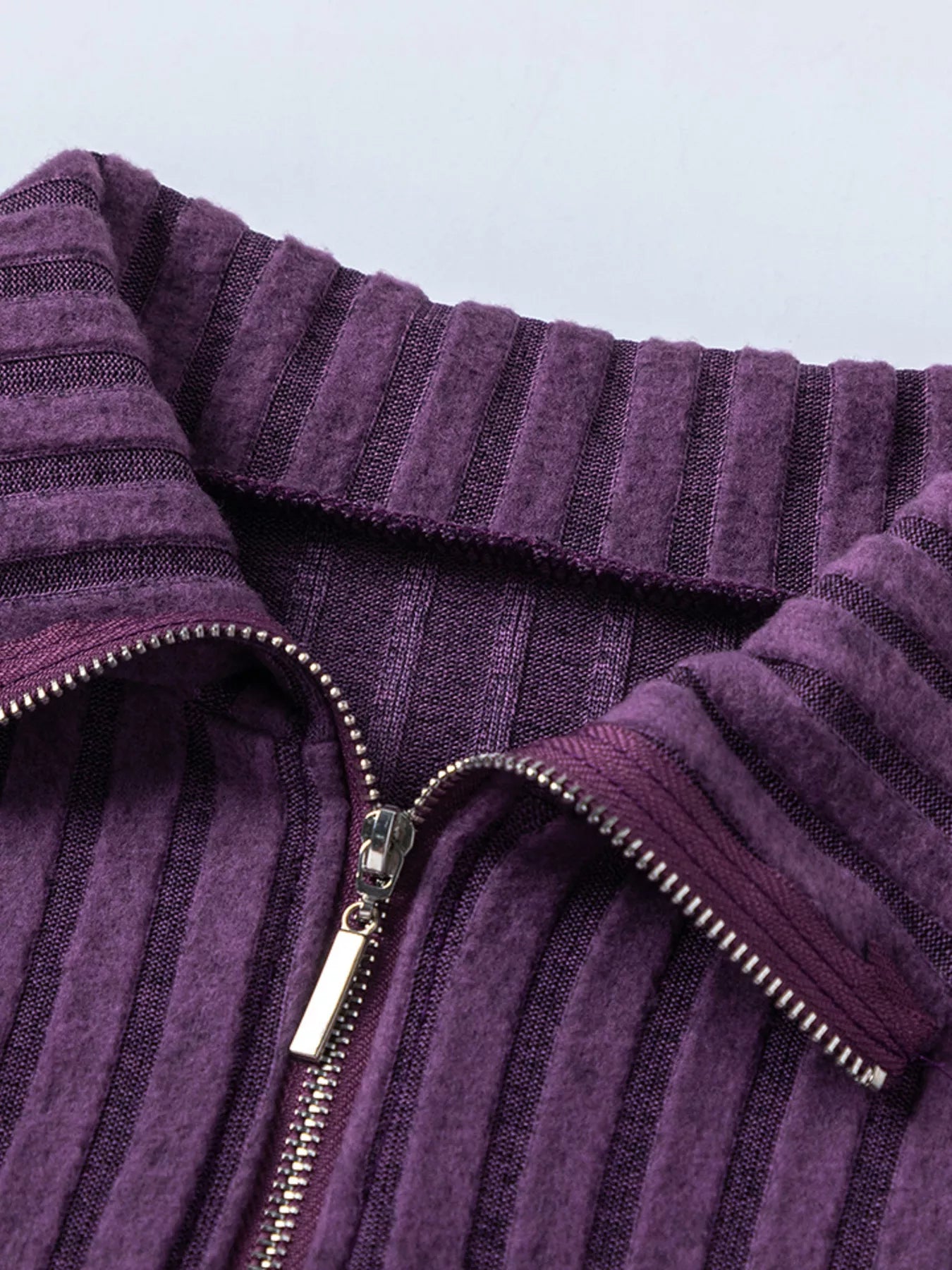 Purple ribbed knit high collar and front zipper detail