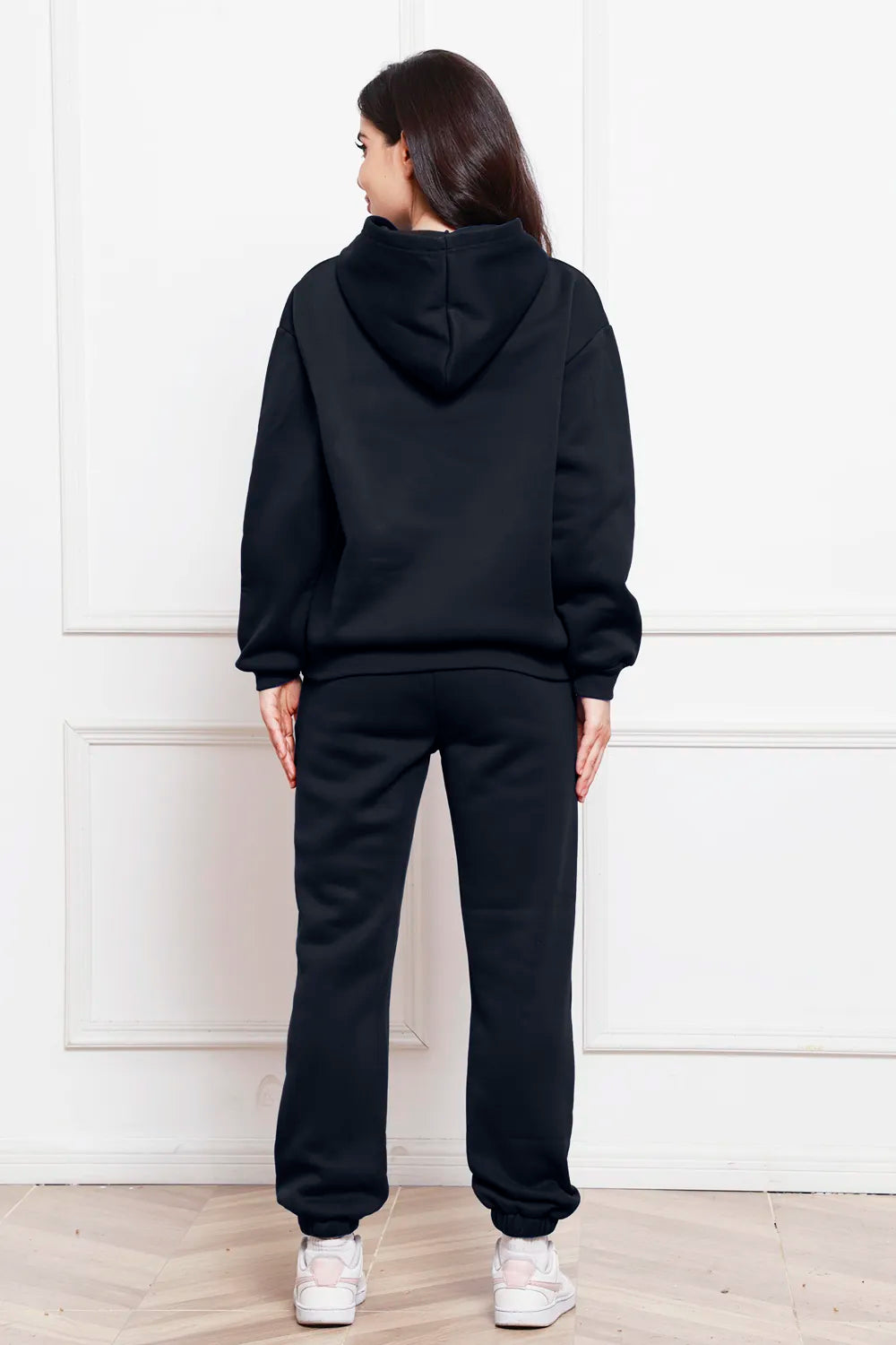 Hoodie and pants set in black, back view with hood and cuffed jogger pants