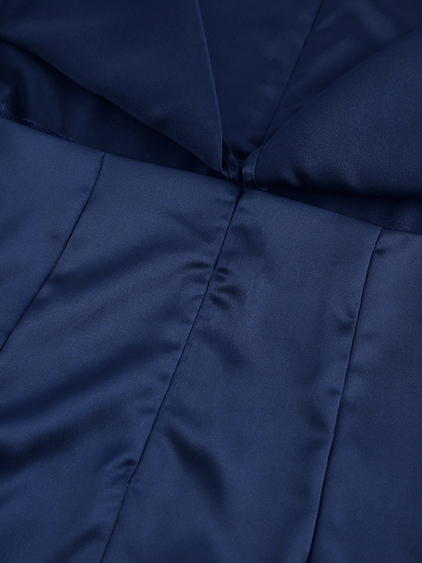 Navy cape sleeve mini dress close-up of center seam and pleated yoke detail