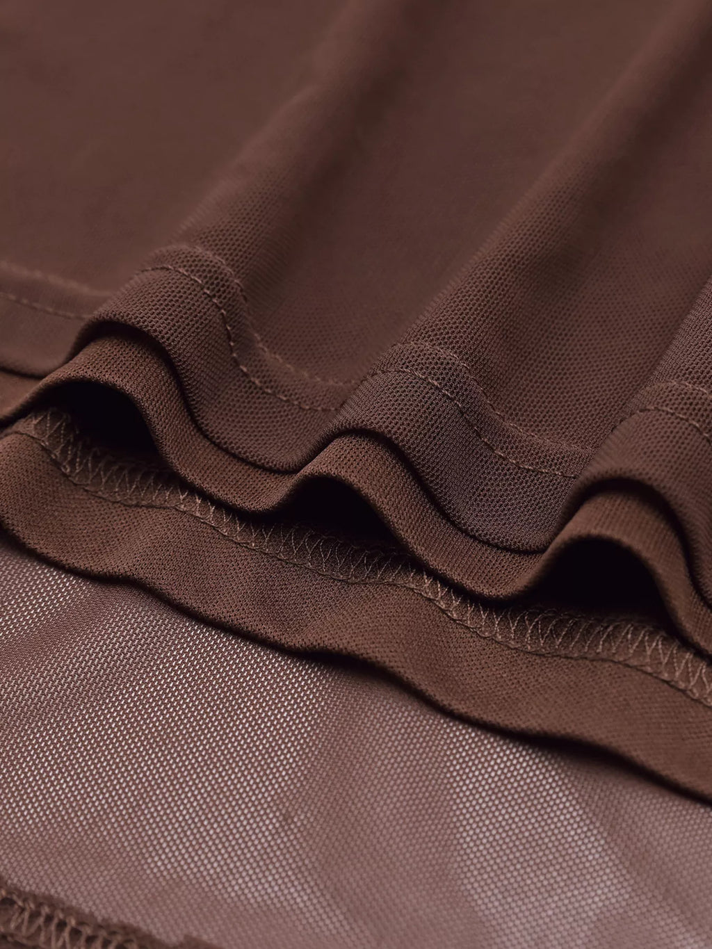 Close-up of brown ruched fabric texture with gathered seam detail
