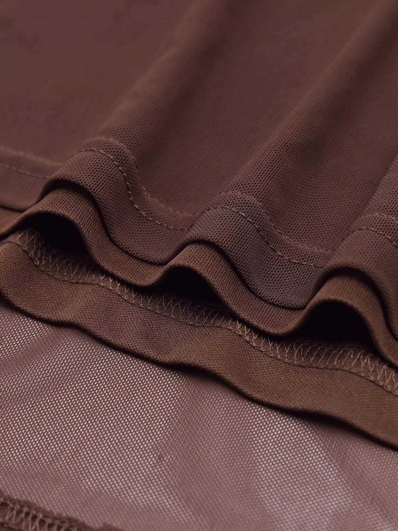 Close-up of brown ruched fabric texture with gathered seam detail