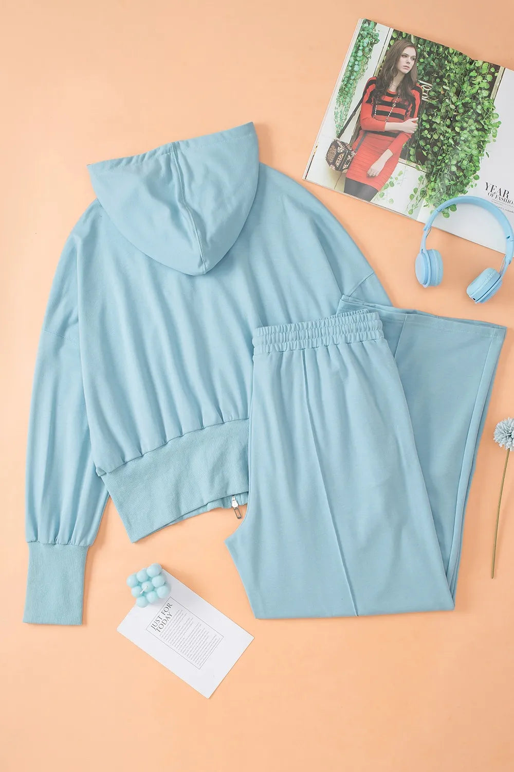 Light blue hooded zip-up hoodie and gathered-waist pants set, accessories shown.