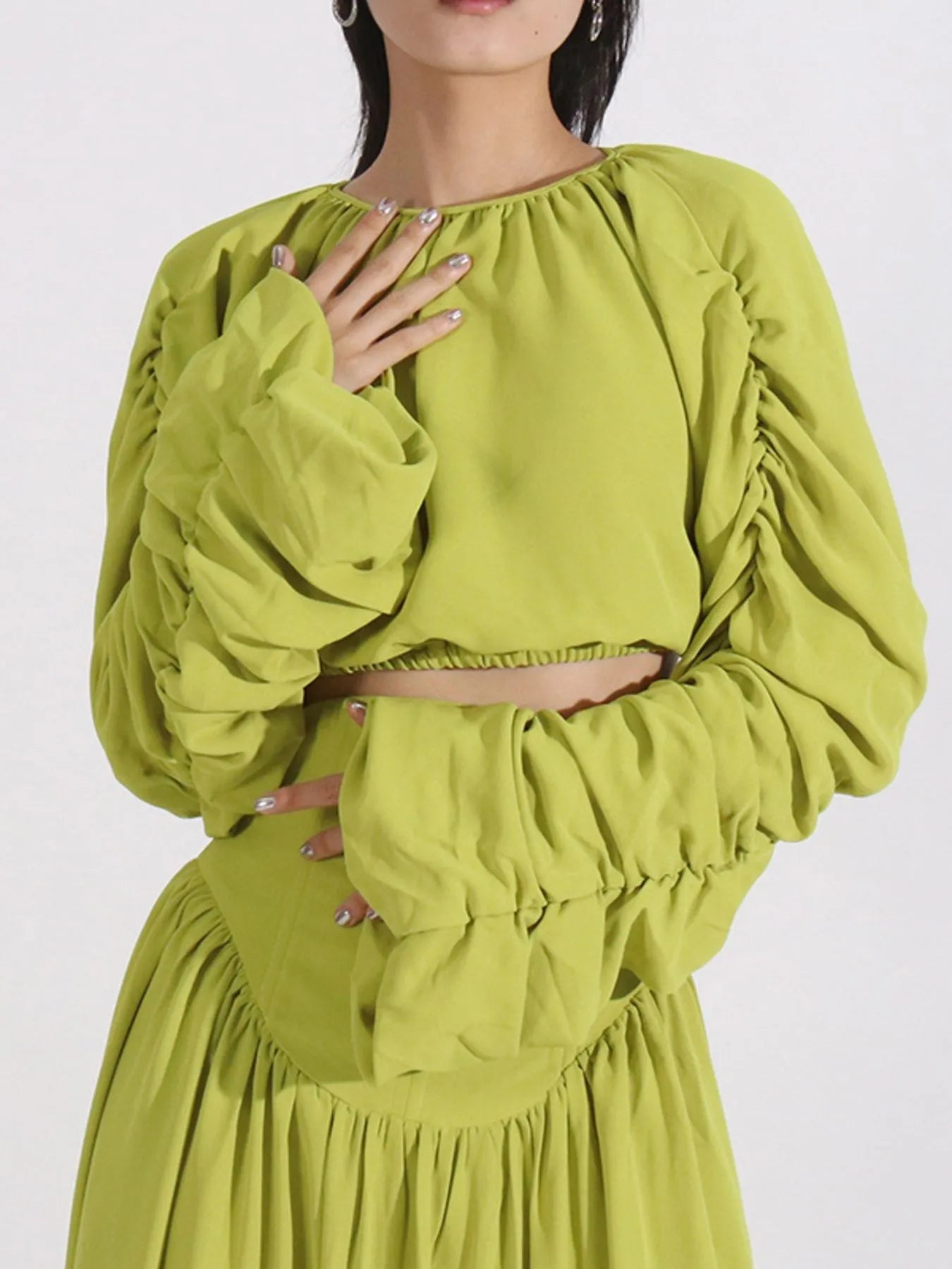 Green ruched long-sleeve crop top with ruffle sleeves and high-waist skirt