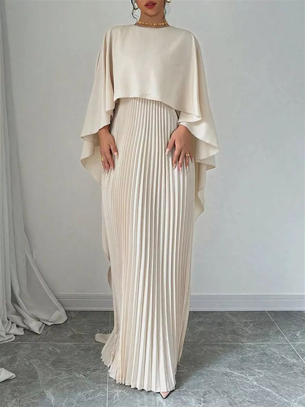 Cream cape pleated maxi dress, loose top with draped sleeves over pleated maxi skirt