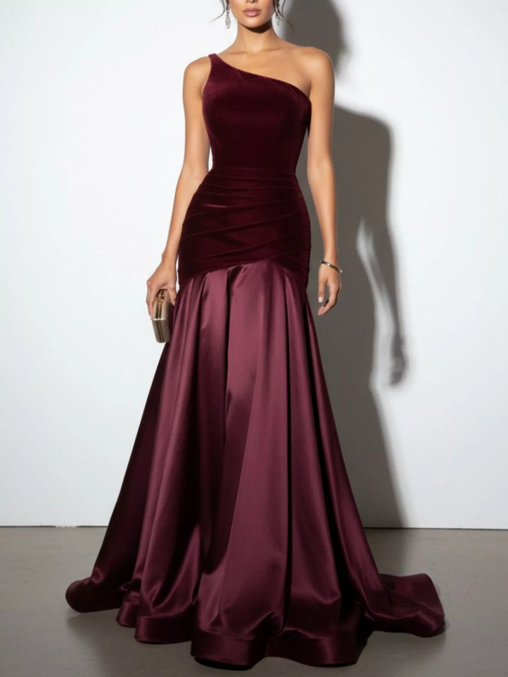 Wine red one-shoulder floor-length dress with fitted bodice and pleated satin skirt