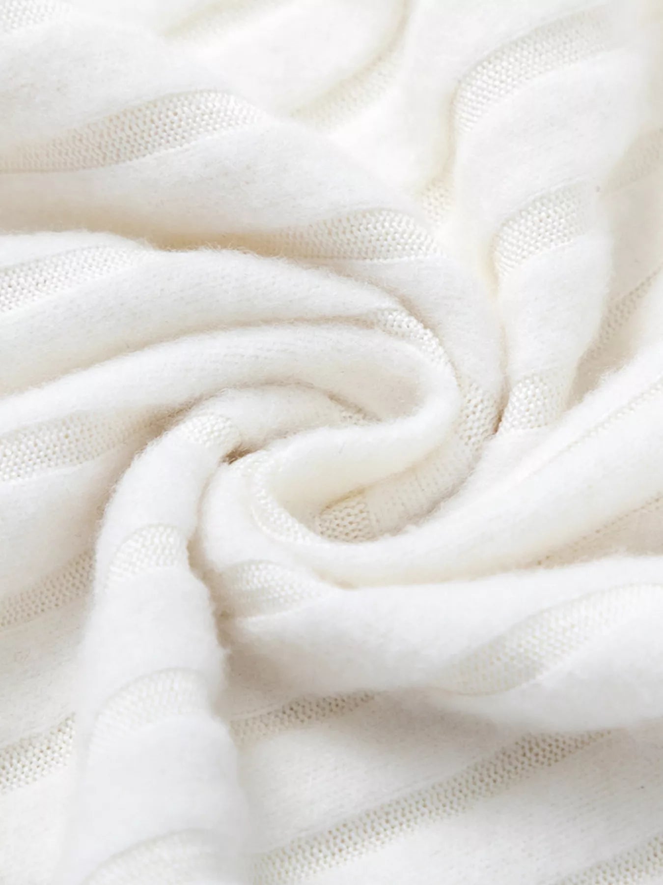 White ribbed knit fabric close-up with soft drape and fine weave