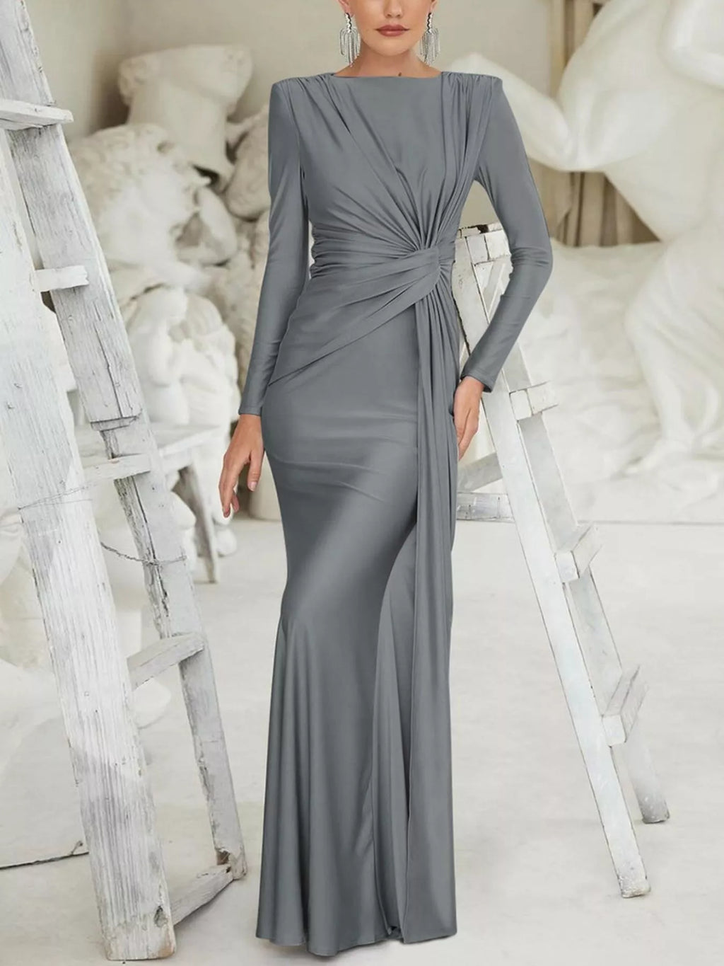 Gray twisted long-sleeve maxi dress with waist knot and draped fitted skirt, full length.