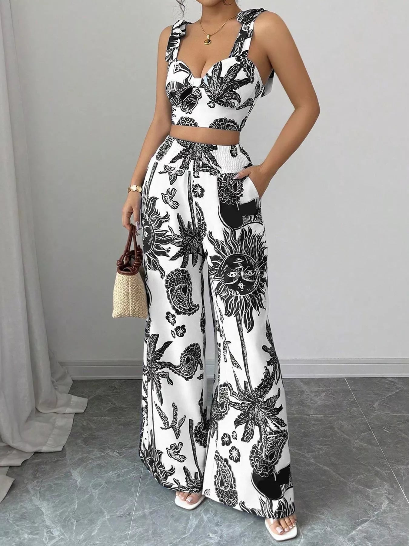 Black-and-white floral print crop top and wide-leg pants set with adjustable waist tie