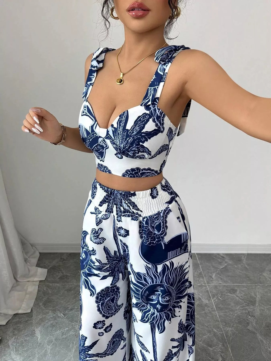 Blue and white floral sleeveless crop top and wide-leg pants set, close-up of neckline