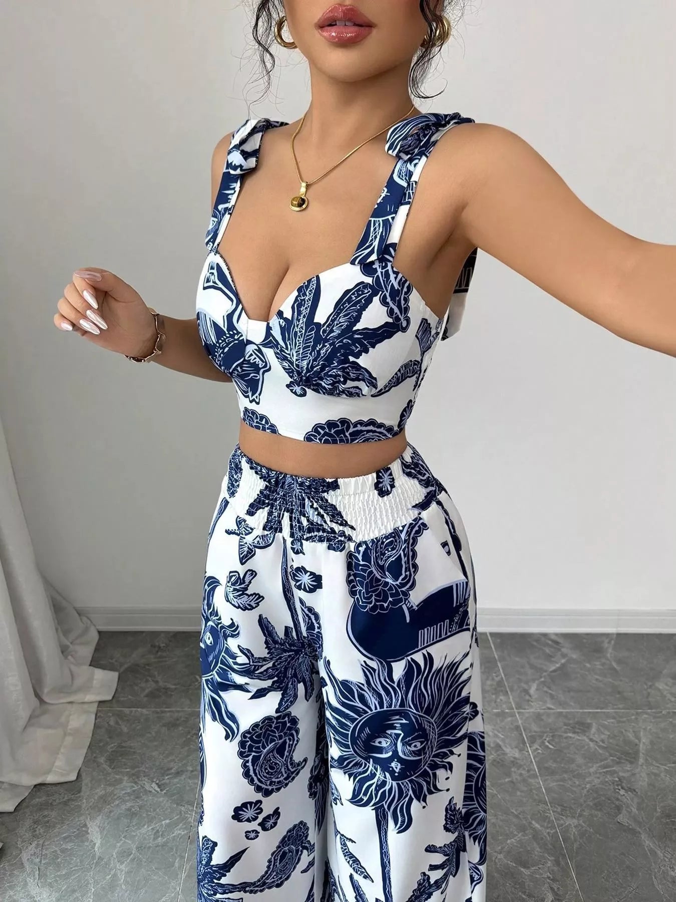 Blue and white floral sleeveless crop top and wide-leg pants set, close-up of neckline