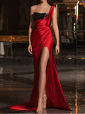 One-shoulder red satin gown with black sequin bodice and high slit