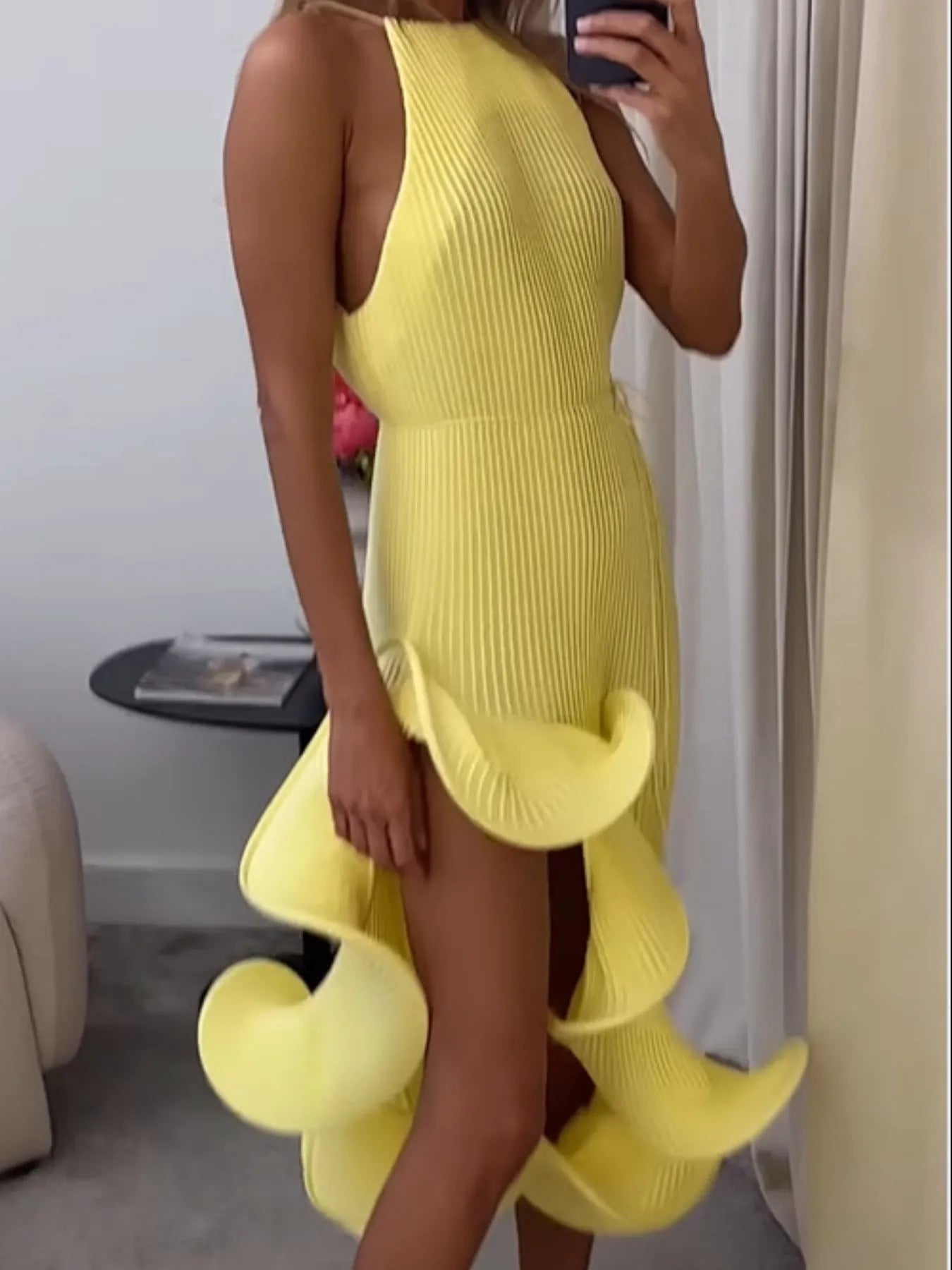 Yellow ribbed sleeveless dress with ruffle hem and side flutter ruffles, fitted waist