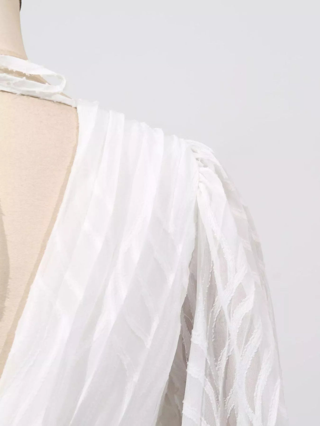White sheer sleeve ruffle with draped fabric and elastic cuff