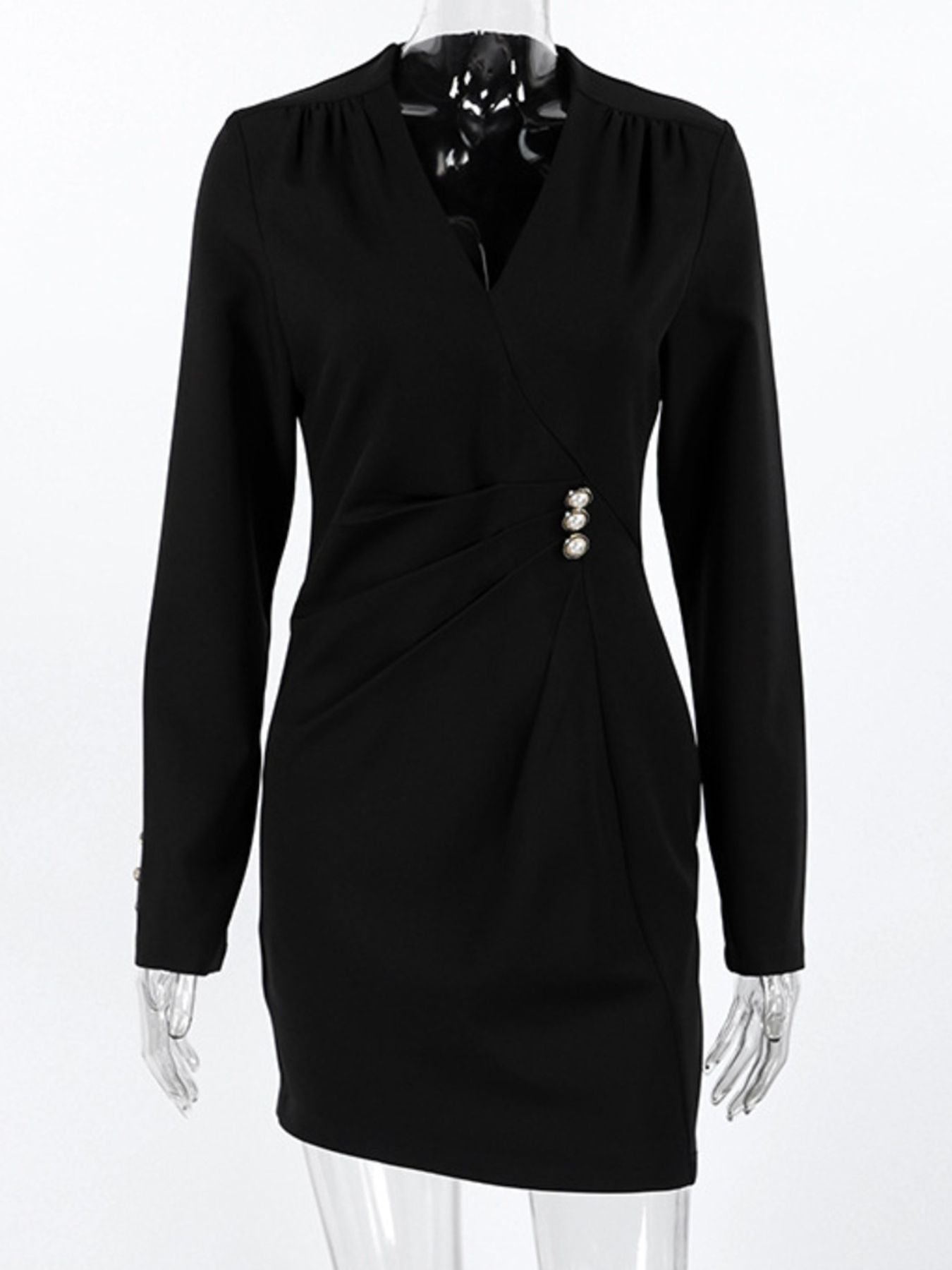 Black long-sleeve surplice dress on a mannequin with pearl button accent at the waist.