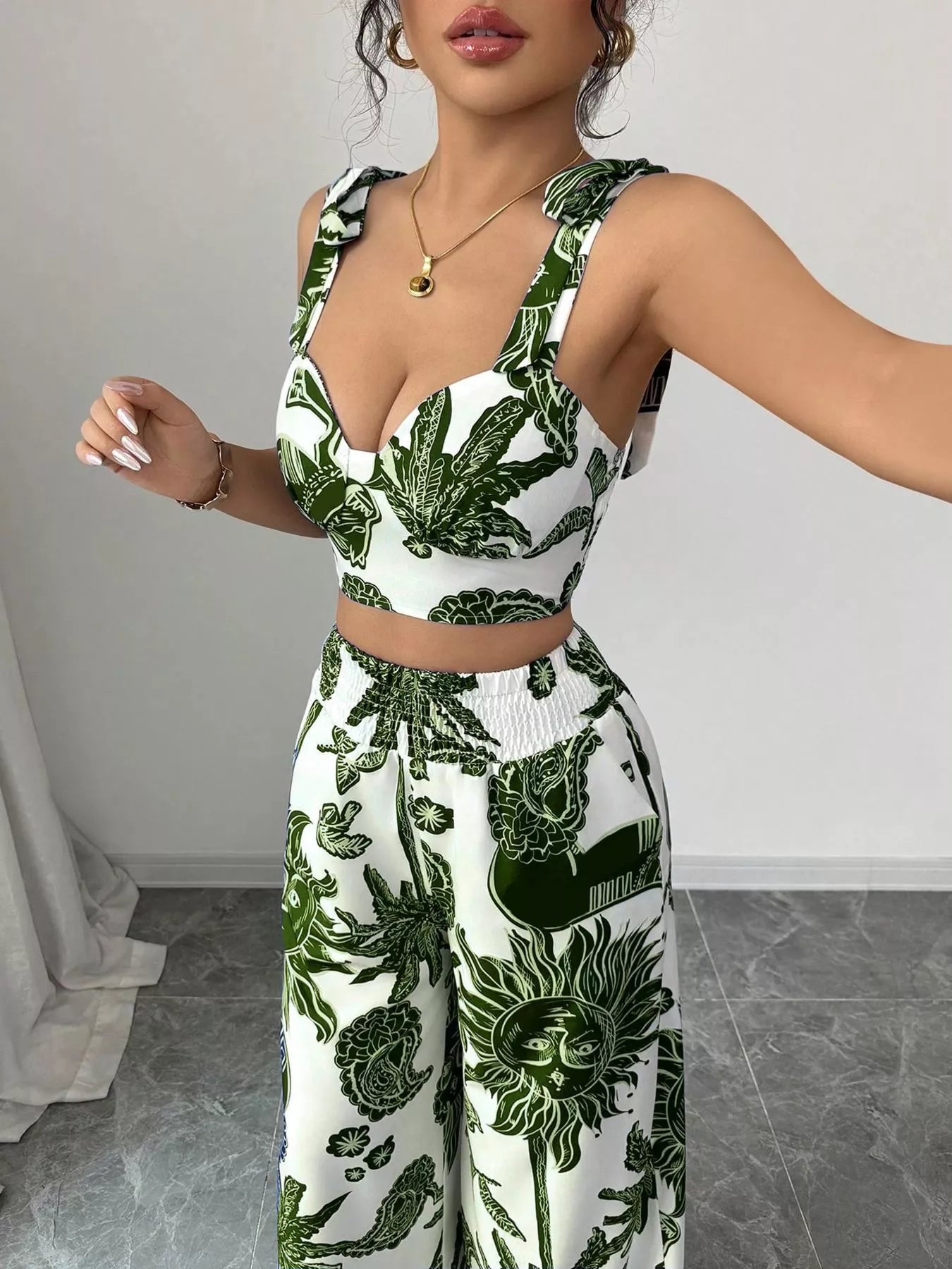 Green and white floral sleeveless crop top and wide-leg pants set, close-up of bodice