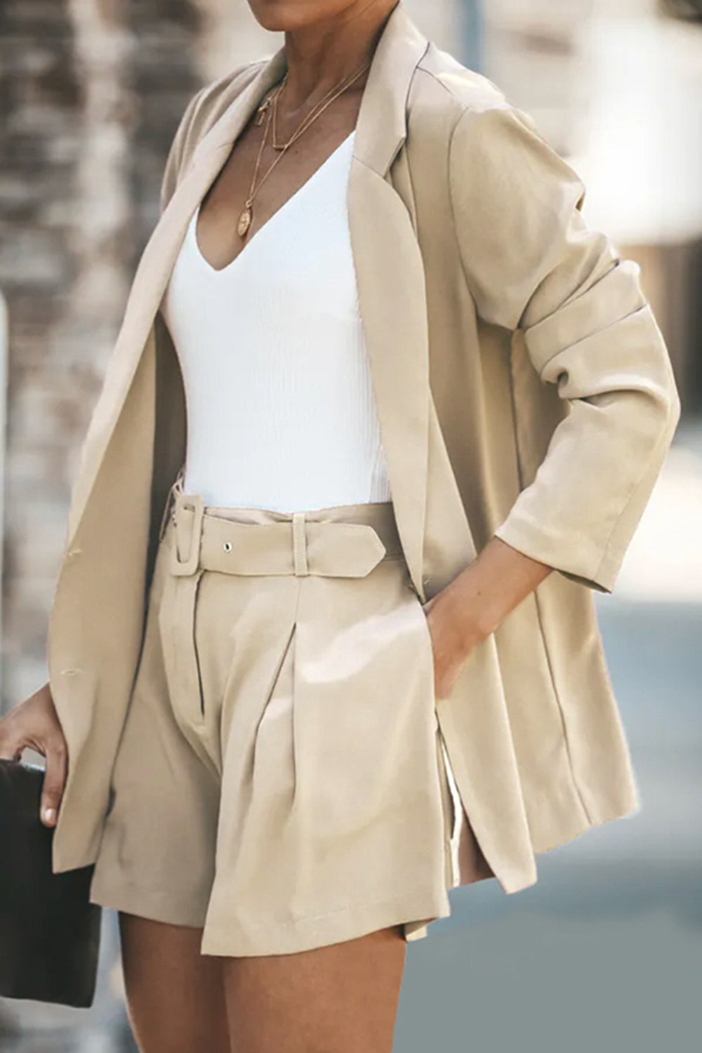 Two-piece blazer and shorts set in camel; long blazer with lapels, belted shorts with front pockets.
