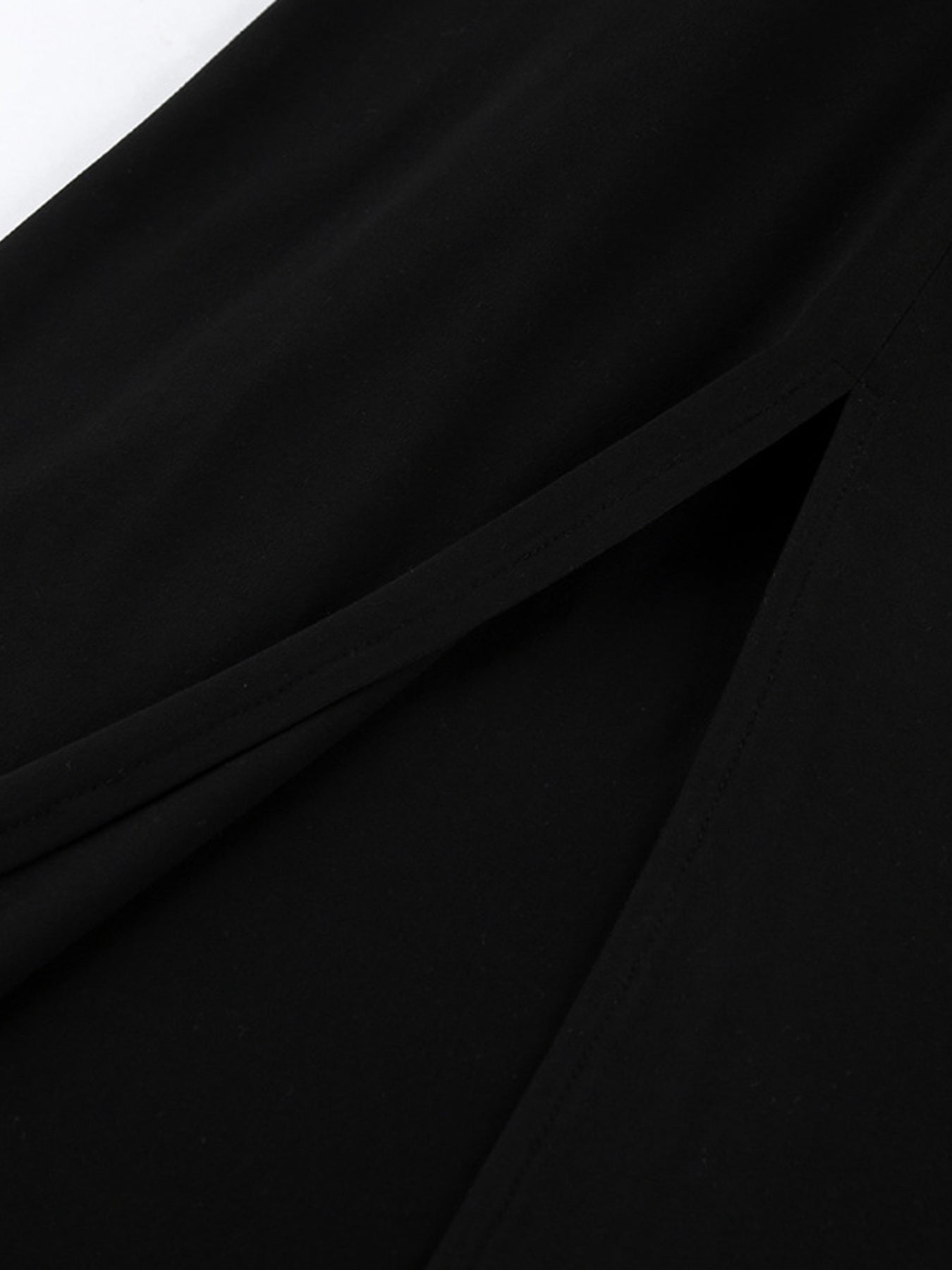 Black bodycon maxi dress with draped seam and diagonal panel detail
