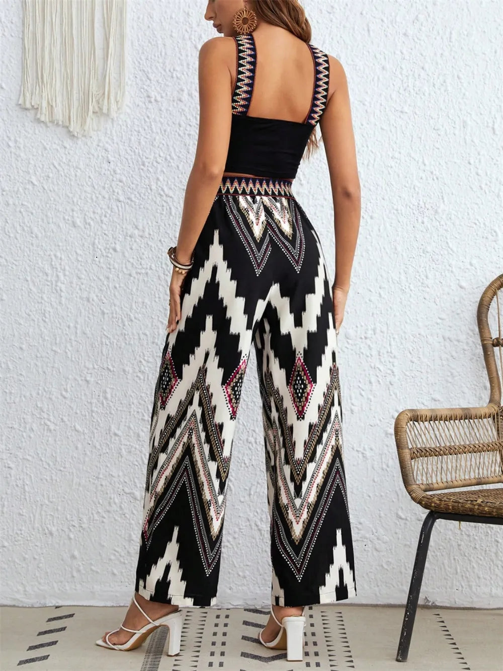 Black wide-strap sleeveless top with zigzag wide-leg pants set, side view