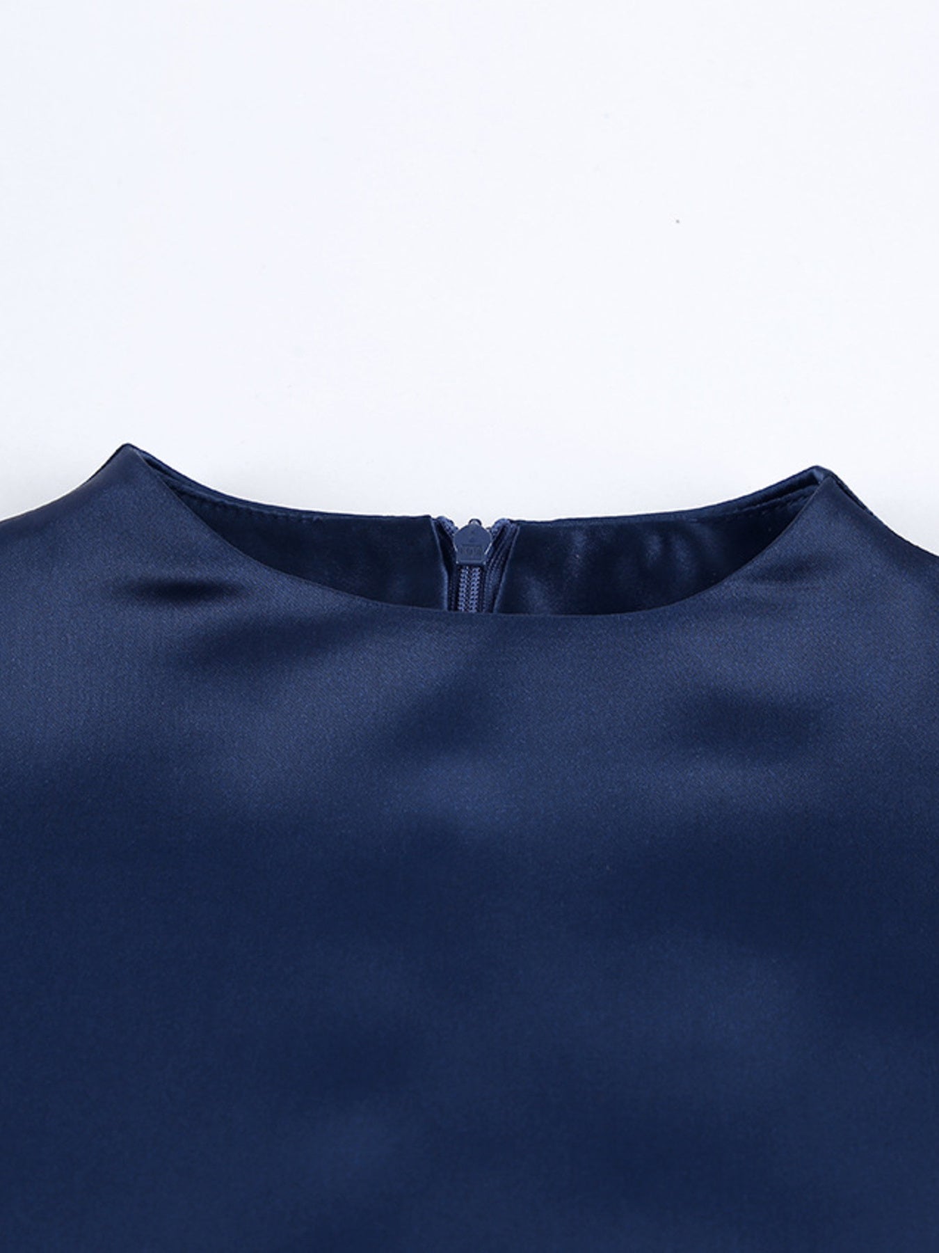 Navy mock neck mini dress close-up of neckline seam and small back tie