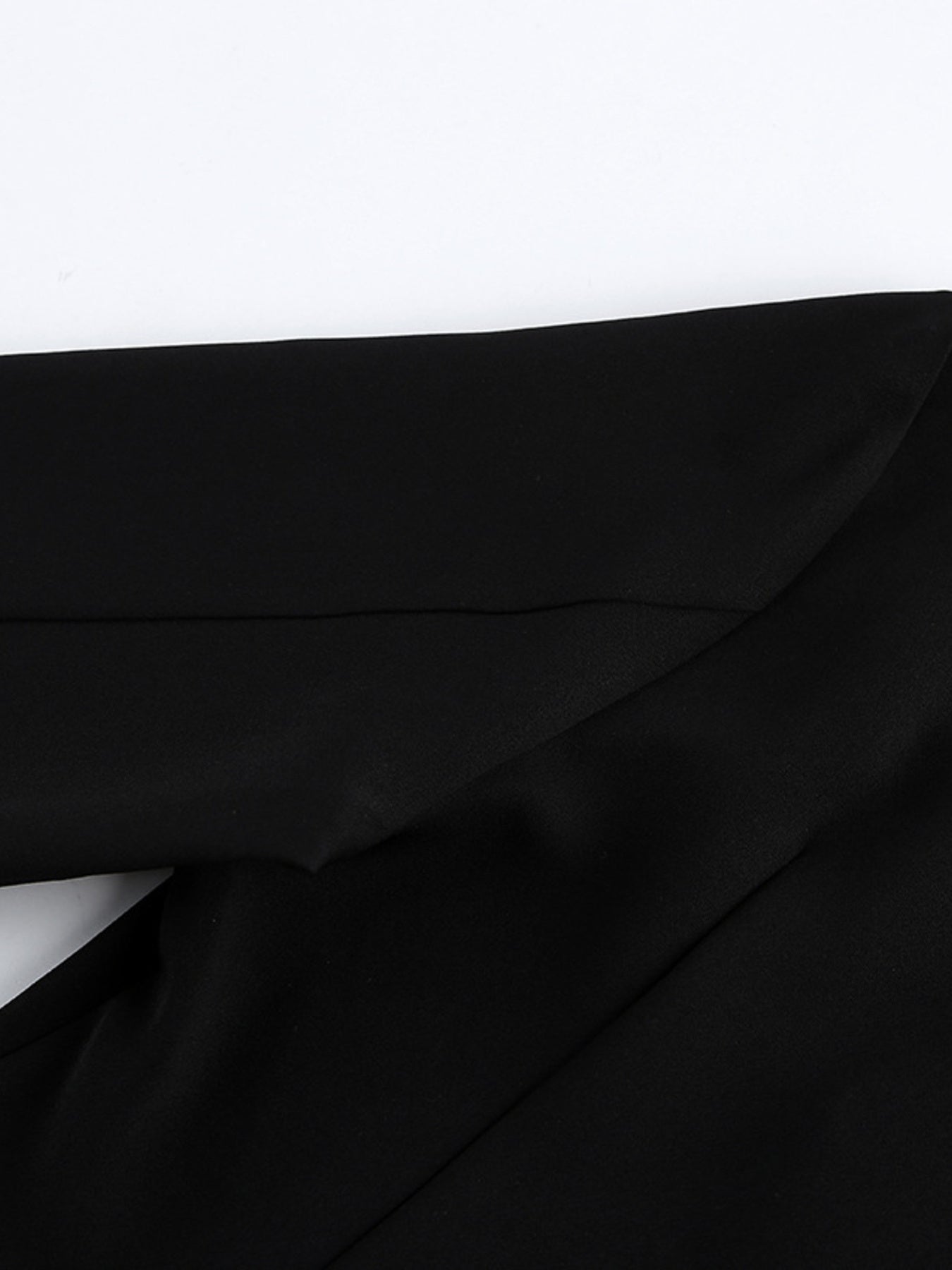 Black ruched surplice long-sleeve dress with draped wrap bodice close-up