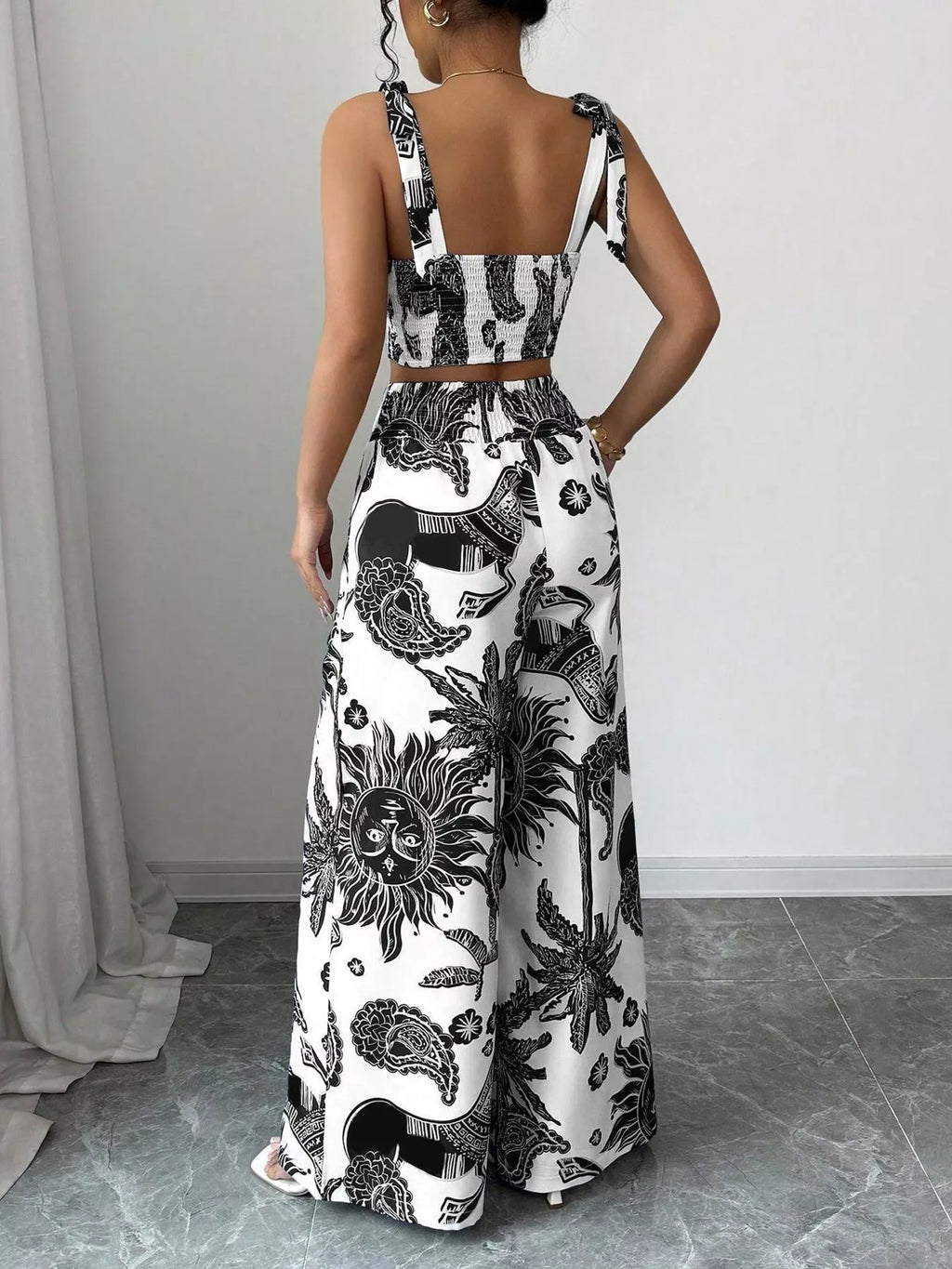 Black-and-white floral print crop top and wide-leg pants set, back view with high waist