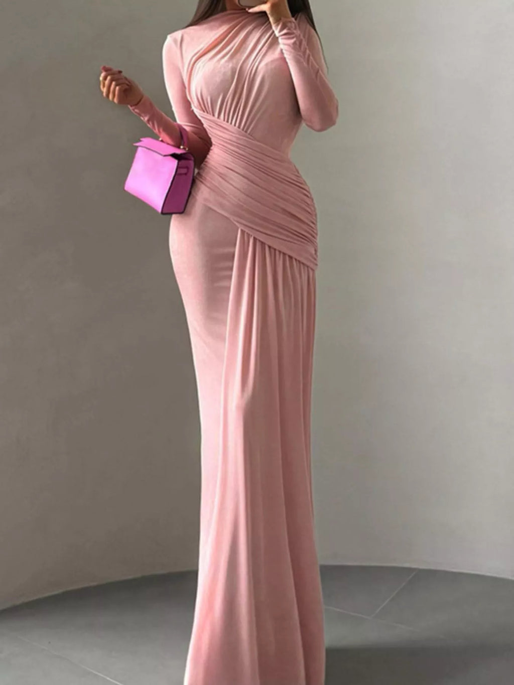 Pink ruched long-sleeve maxi dress with high neckline and flowing pleated skirt