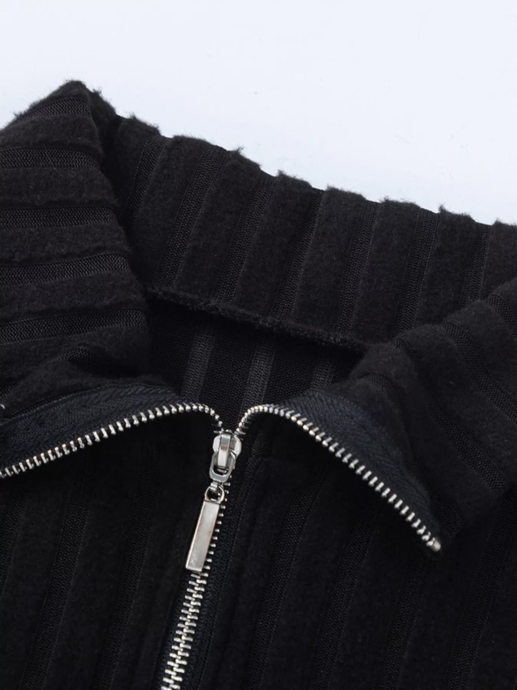 Black ribbed knit high collar and front zipper detail