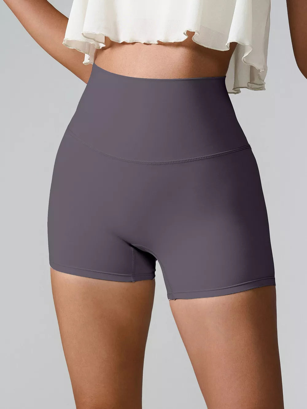 High-waist active shorts, dark charcoal-purple, fitted mid-thigh