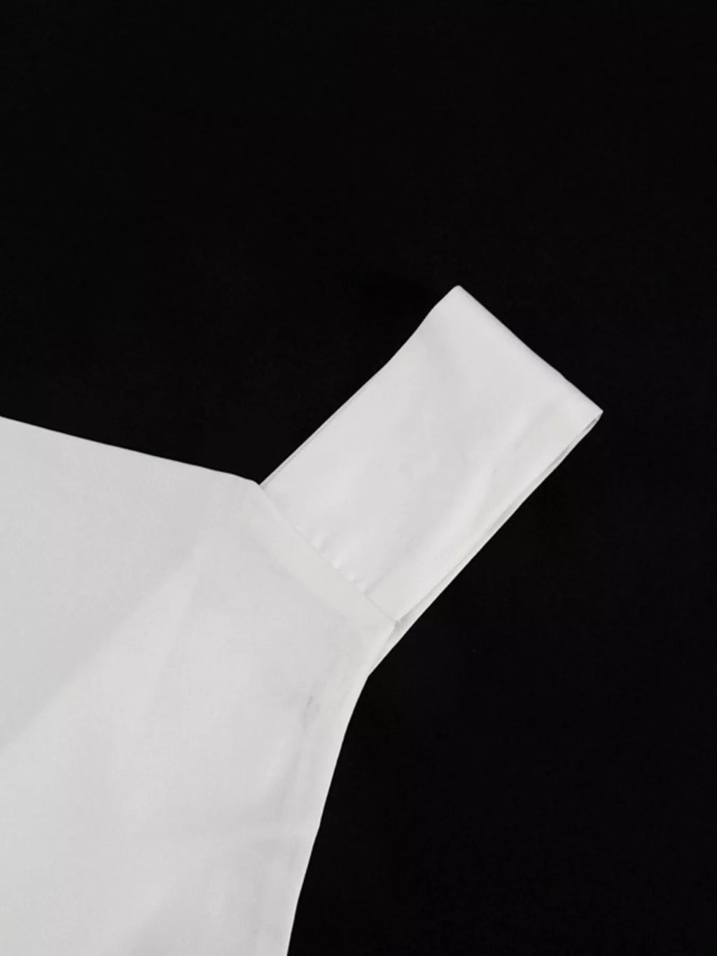 White halter neck mini dress neckline close-up with smooth shoulder-to-neck seam