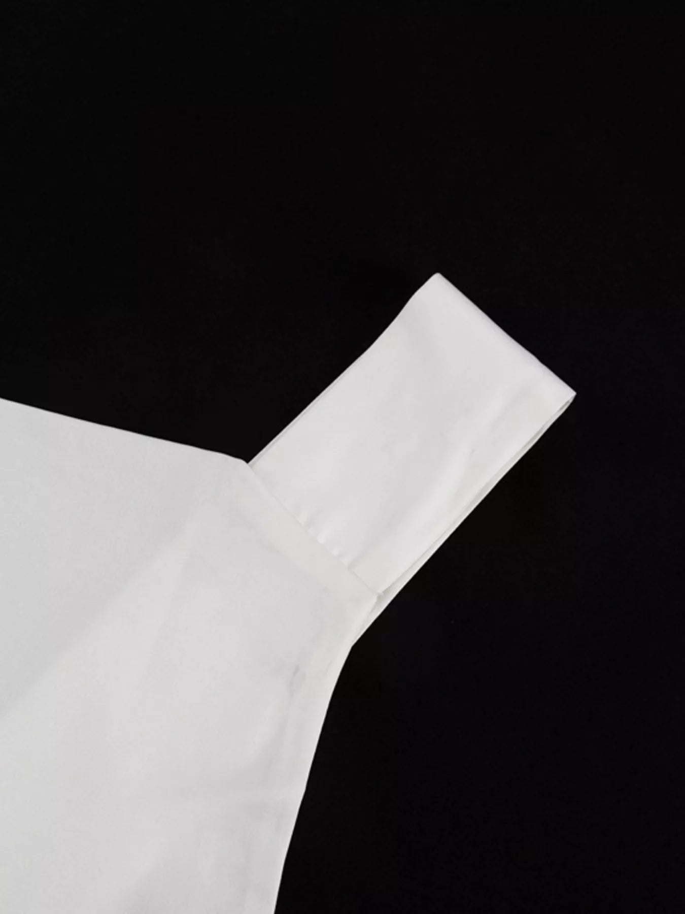 White halter neck mini dress neckline close-up with smooth shoulder-to-neck seam
